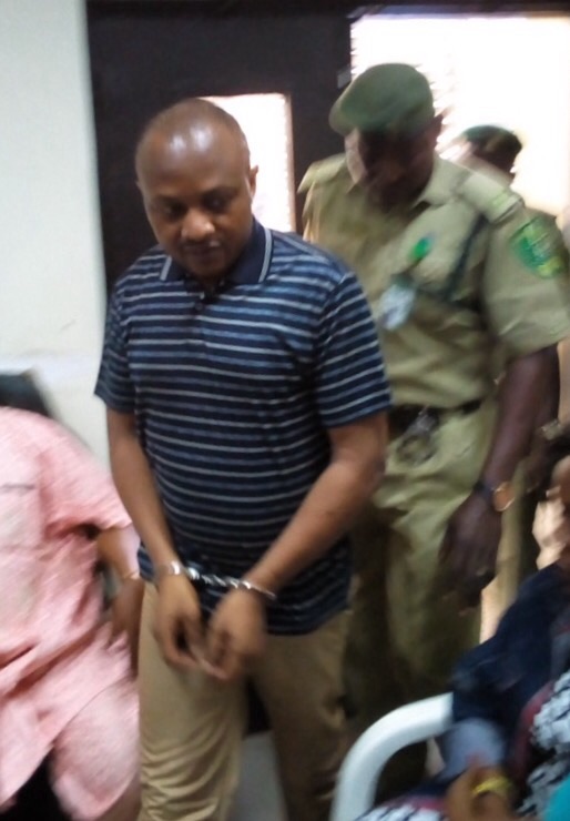 Evans being led to court in handcuffs during one of his appearances.