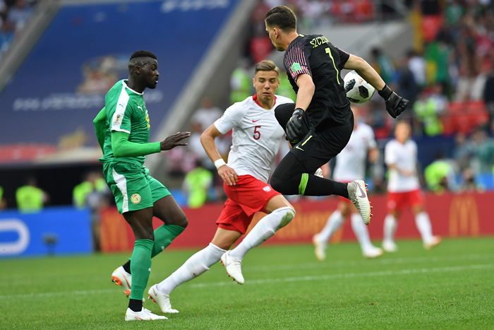 Poland's goalkepper, Wojciech Szczesny, misses the ball to let in Senegal's second goal.