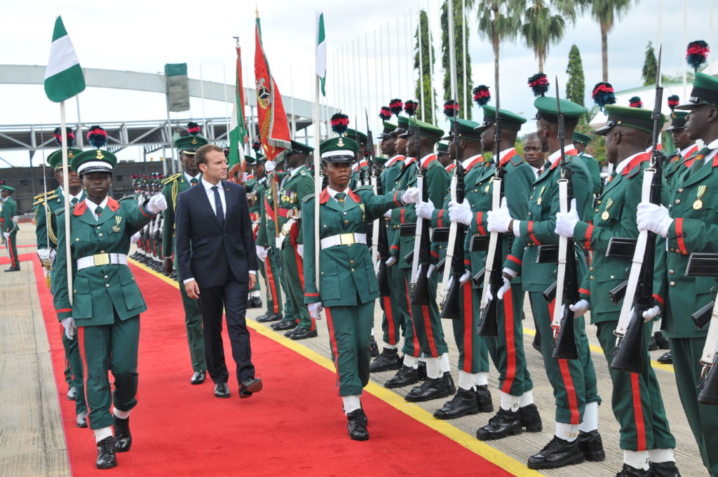 President Emmanuel Macron of France inspecting a Guard of honour during his arrival at the Nnamdi Azikiwe International Airport in Abuja