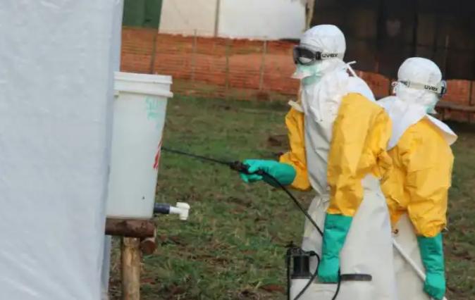 Heath workers fumigating an Ebola centre in Kivu.