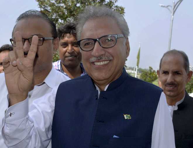 Pakistan newly elected President Arif Alvi, a dentist, flashes a smile.