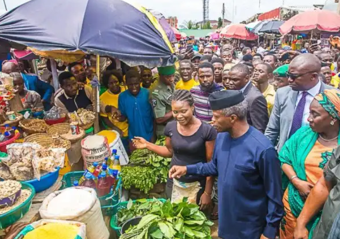 Vice President Yemi Osinbajo interacting with traders during the launch of Tradermoni at Utako market in Abuja