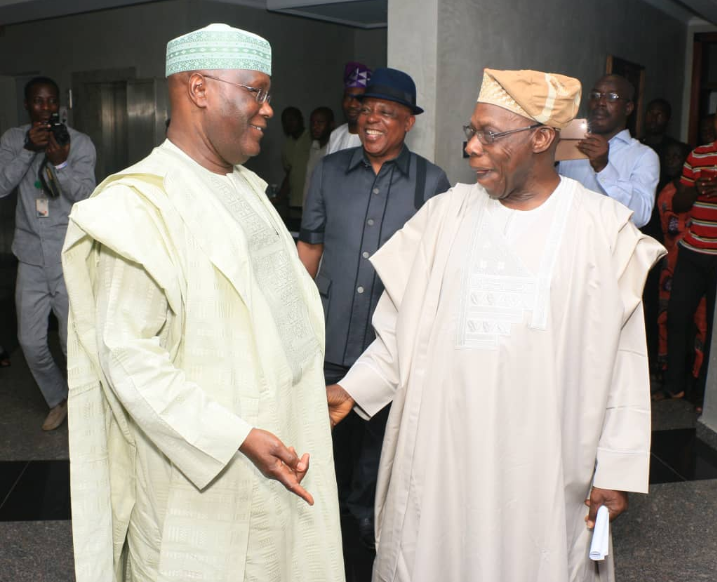 Alhaji Atiku Abubakar (left) and former President Olusegun Obasanjo after their meeting in Abeokuta today. Behind them is PDP's national chairman, Mr Uche Secondus