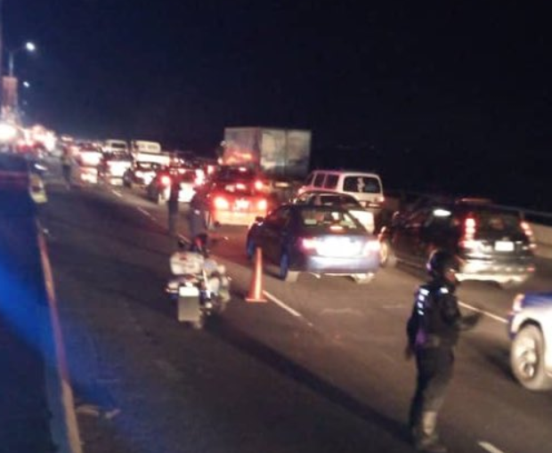 A police officer directing traffic at the scene of the fire on the Third Mainland Bridge