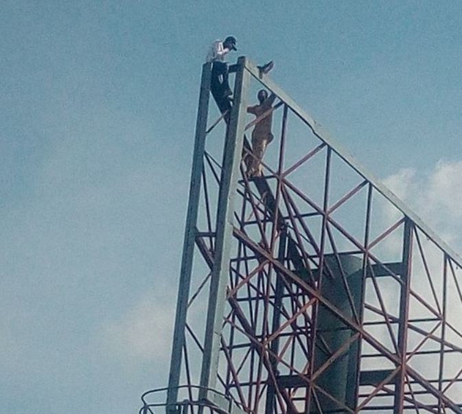 Lawan Yaro, left, being persuaded to shelve his suicide bid