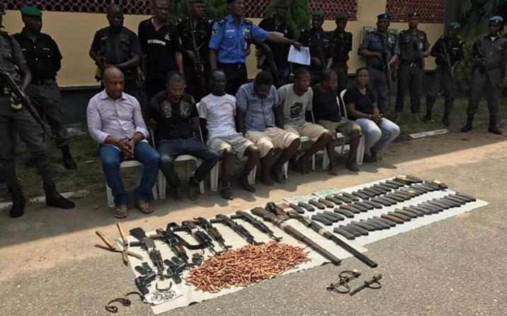 Evans and his gang members being paraded with the arms and ammunition allegedly recovered from them by the police.