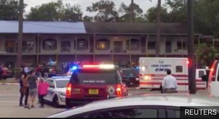 Police vehicles and ambulances outside the Florida yoga studio where a gunman killed two persons and injured four others.