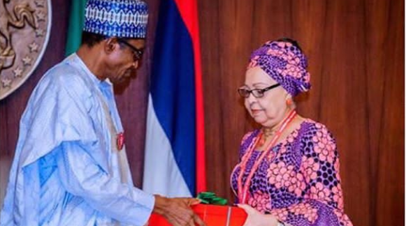 President Muhammadu Buhari receiving the committee's report from its chairman, Amal Pepple, at the State House, Abuja