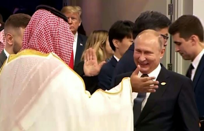 Saudi Crown Prince Salman and President Vladimir Putin in an effusive handshake. Trump steals a glance