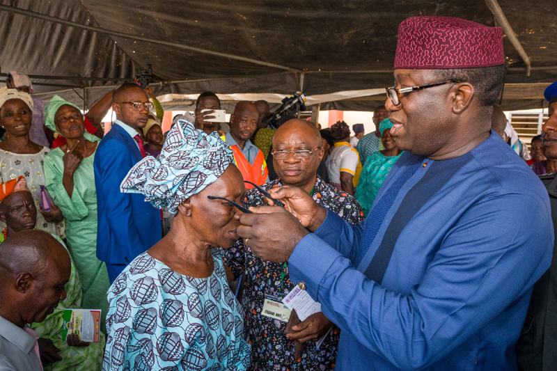 Ekiti State Governor, Dr Kayode Fayemi, presenting an eye glasses to an elderly citizen, Madam Maria Ajayi, at the flag off of the quarterly Free Medical Mission of the state government in Iker-Ekiti…on Wednesday