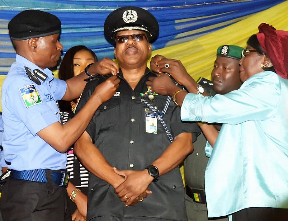 Newly promoted Deputy Inspector General of Police, DIG Taiwo Lakanu being decorated by the Inspector General of Police, Mohammed Adamu today