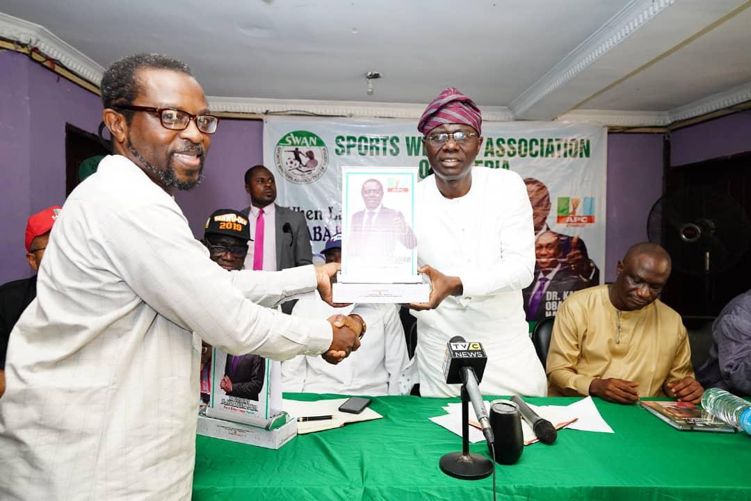 Mr. Yomi Opakunle, renowned Sport Journalist and broadcaster presenting a picture frame to Mr. Babajide Sanwo-Olu, All Progressives Congress Governorship candidates in Lagos State during an engagement with leadership and members Sports Writers Association of Nigeria (SWAN) at the National Stadium, Surulere