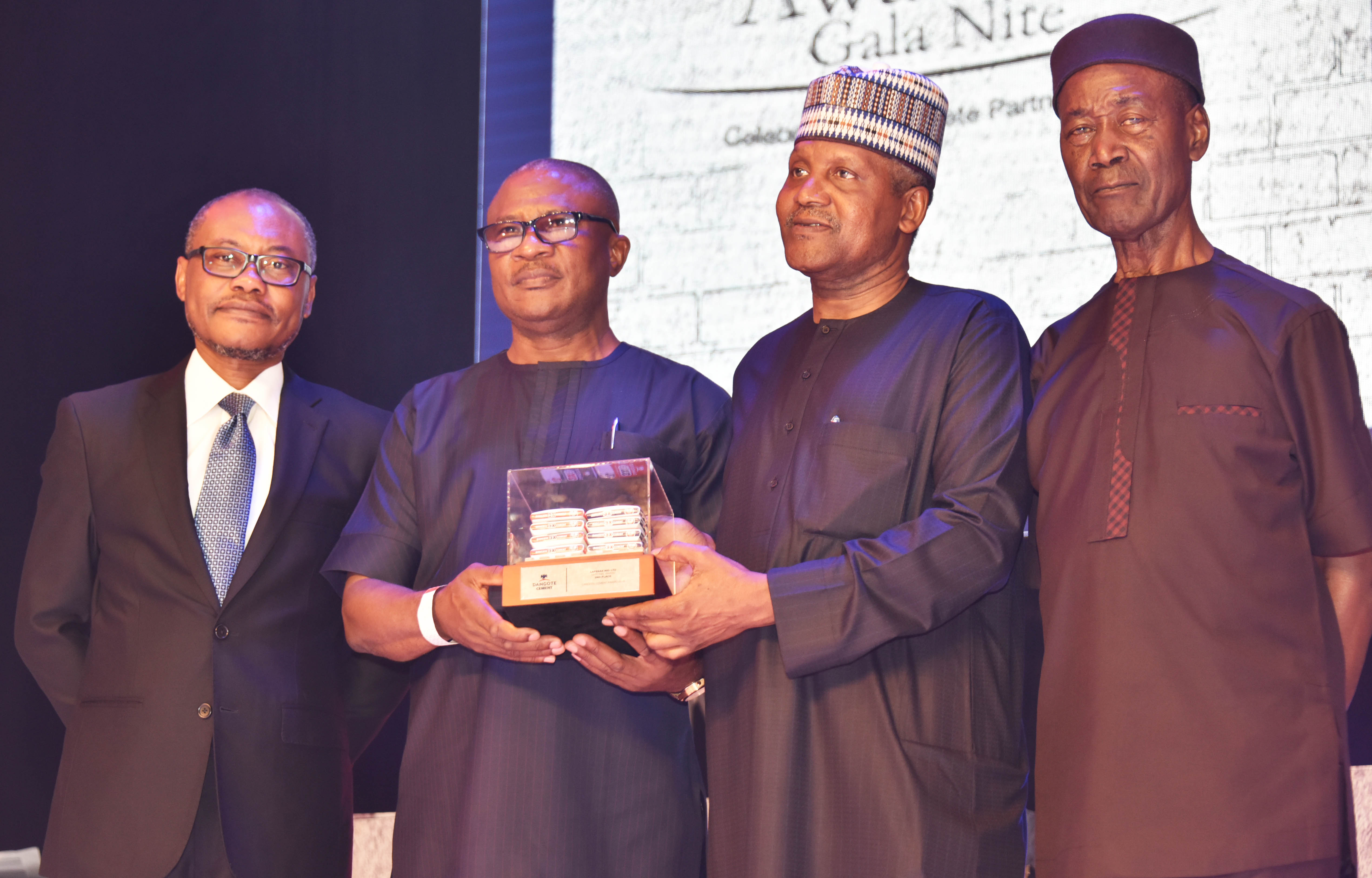 Group Managing Director, Dangote Industries Limited, Olakunle Alake; Best National Distributor of Dangote Cement, Mrs. Beatrice Okika, MD, D. C. Okika Nig. Ltd., receiving an award from President/CE, Dangote Industries Limited, Aliko Dangote; and Group Managing Director, Dangote Cement Plc, Engr. Joseph Makoju at the Dangote Cement Plc 2018 Distributors Award Night, in Lagos on Monday, March 4, 2019