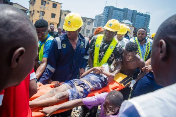 One of the victims of the collapsed building on Lagos Island being taken away by LASEMA officials