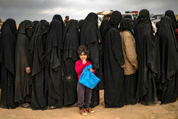 Women queue at a screening point in Syria after fleeing Islamic State shrunk territory