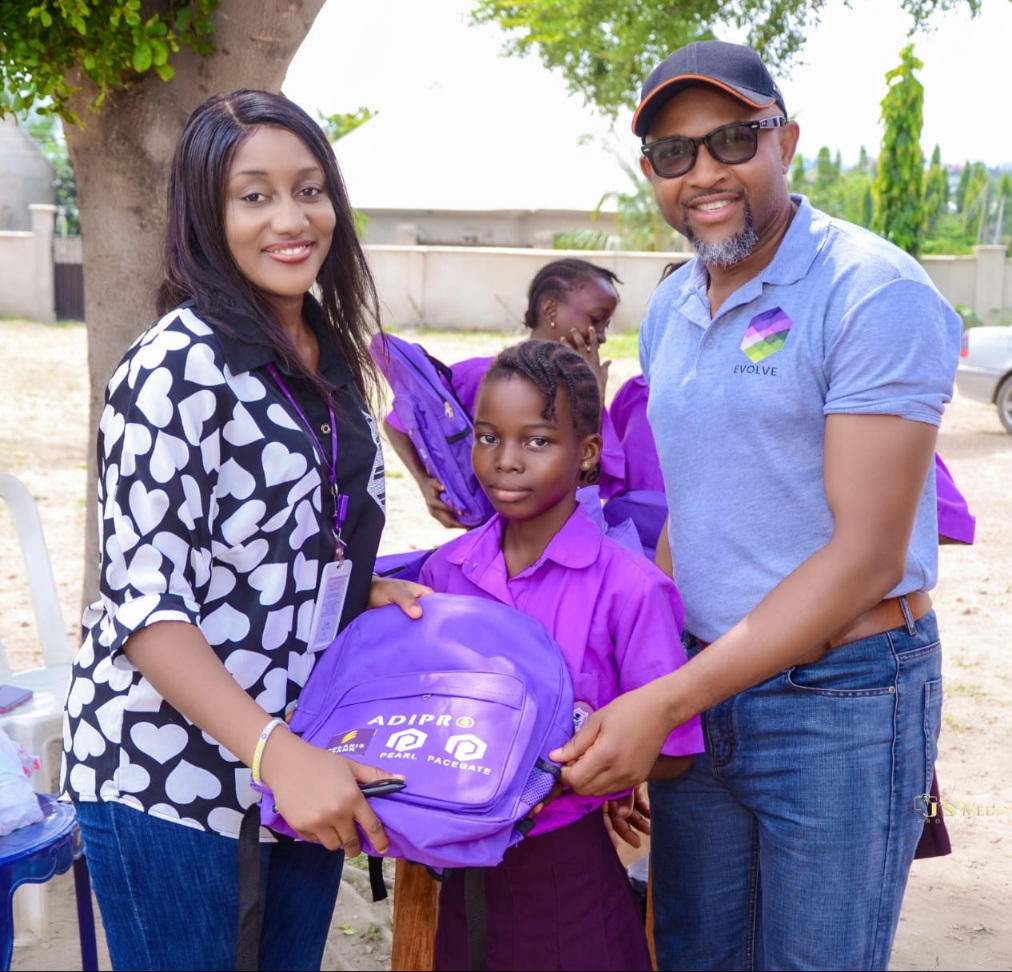 From Left Relationship Officer, Polaris Bank, Abimbola Mahmoud; one of the beneficiaries and student of Fortune Schools International, Lokoja, Rabiat Muhammad, and General Manager, Evolve Charity, Godwin Ejeh; at the presentation of school bags, sandals, books, pens and school uniforms to Fortune Schools International, Lokoja during the ongoing CSR Partner in The Girl-Child Education Project in Lokoja, Kogi State.